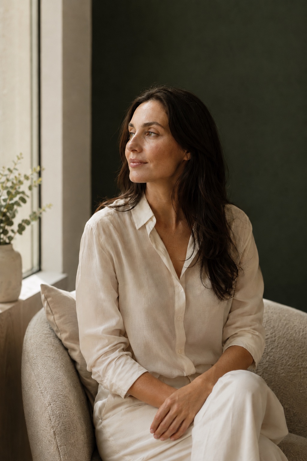 Calm editorial portrait seated in quiet window light